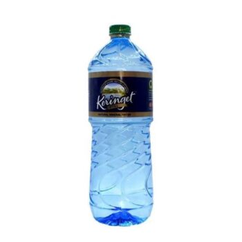 A clear plastic 1-litre bottle of branded generic mineral water with condensation and water droplets, sitting on a rustic, dark wooden fast-food counter in Kilimani.