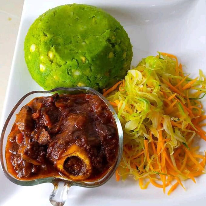 A hearty plate of traditional Kenyan Mukimo mashed with pumpkin leaves, served with rich, slow-cooked beef stew from Let's Fry Away.